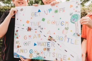 Image of local school students holding their Walk to School poster