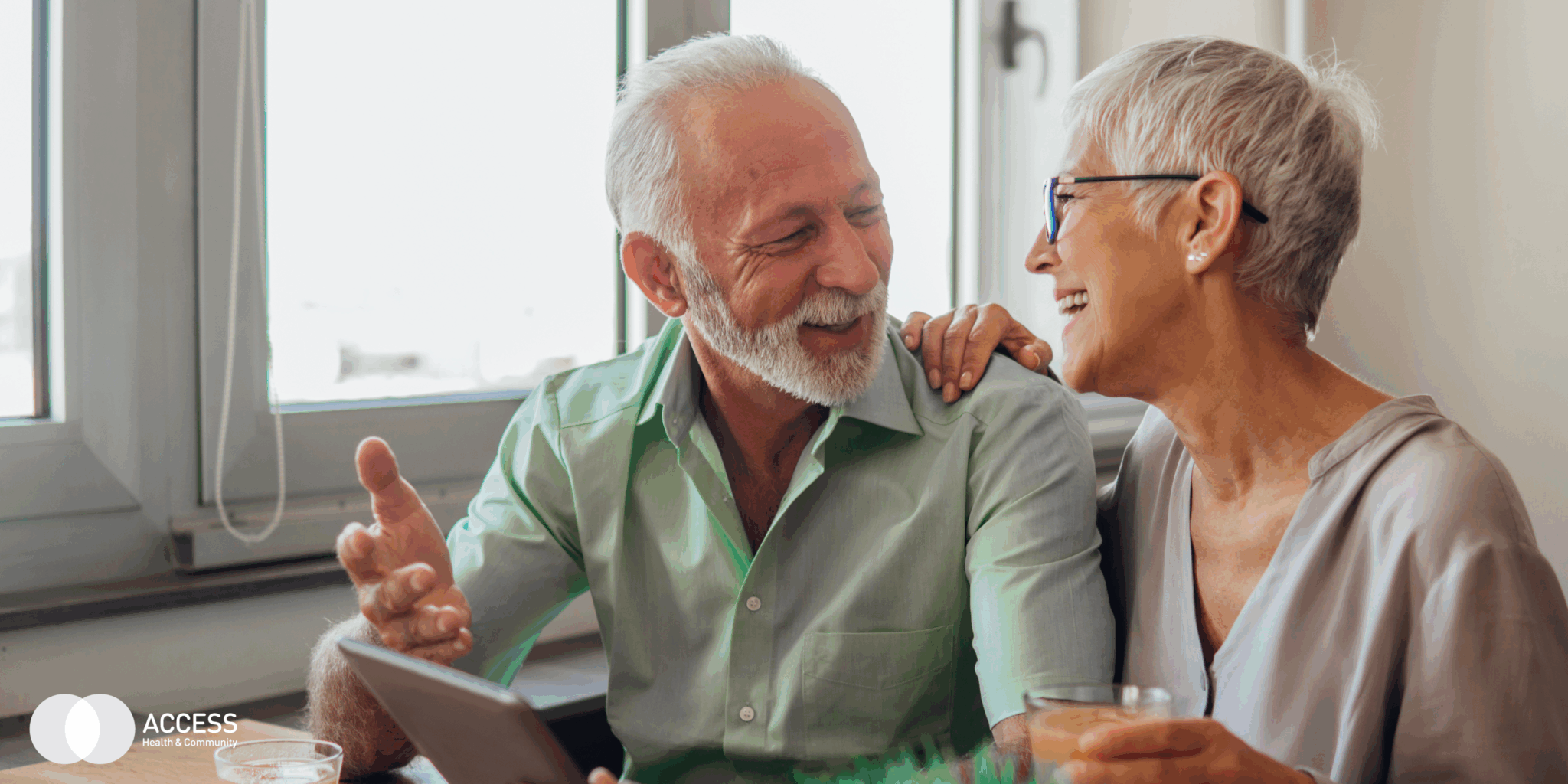 Two people at home looking at each other smiling.